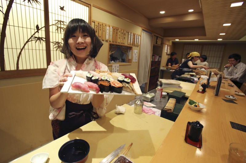 YURI KAGEYAMA STORY; Manager of sushi restaurant "Nadeshiko sushi" Yuki Chidui shows off sushi which she made at restaurant in Tokyo, Monday, Aug. 3, 2015. (AP Photo/Koji Sasahara)