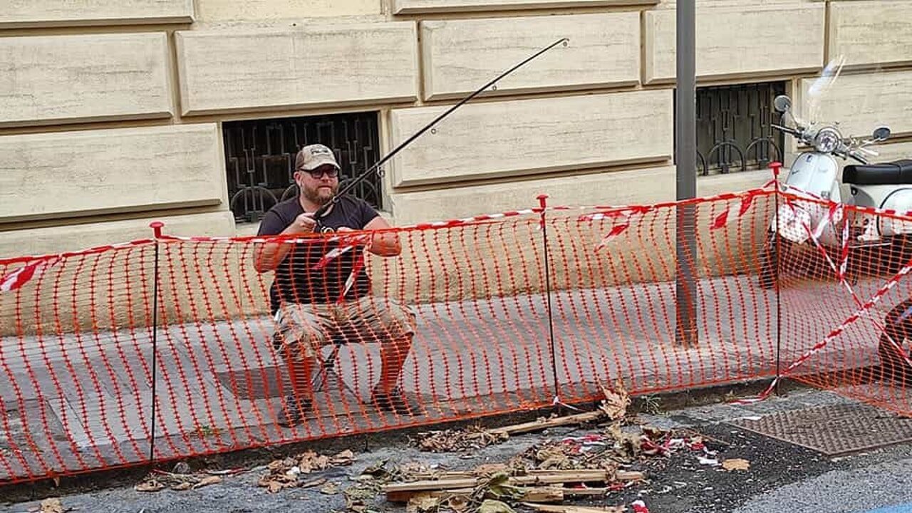 Napoli, si siede a pescare in una buca stradale nel quartiere Vomero: la foto diventa virale